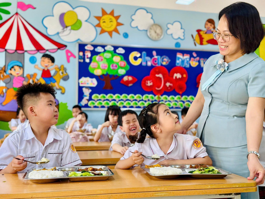 Hiệu trưởng Trường Tiểu học Nam Trung Yên Trịnh Thị Chung Thủy tới thăm học sinh trong một giờ ăn trưa. yen-hoa.jpg