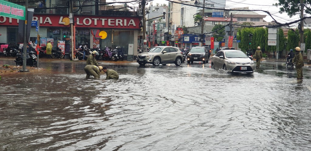 CSGT đang moi rác tại điểm ngập khu vực Cung thiếu nhi Thủ Đức trưa ngày